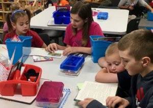 a group of students working on their reading