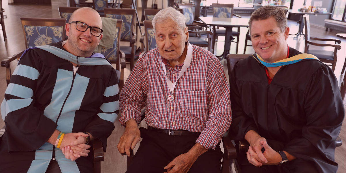 Dr. Scott Blum, Paul Little and Matthew Blackmore gather after the surprise gradation